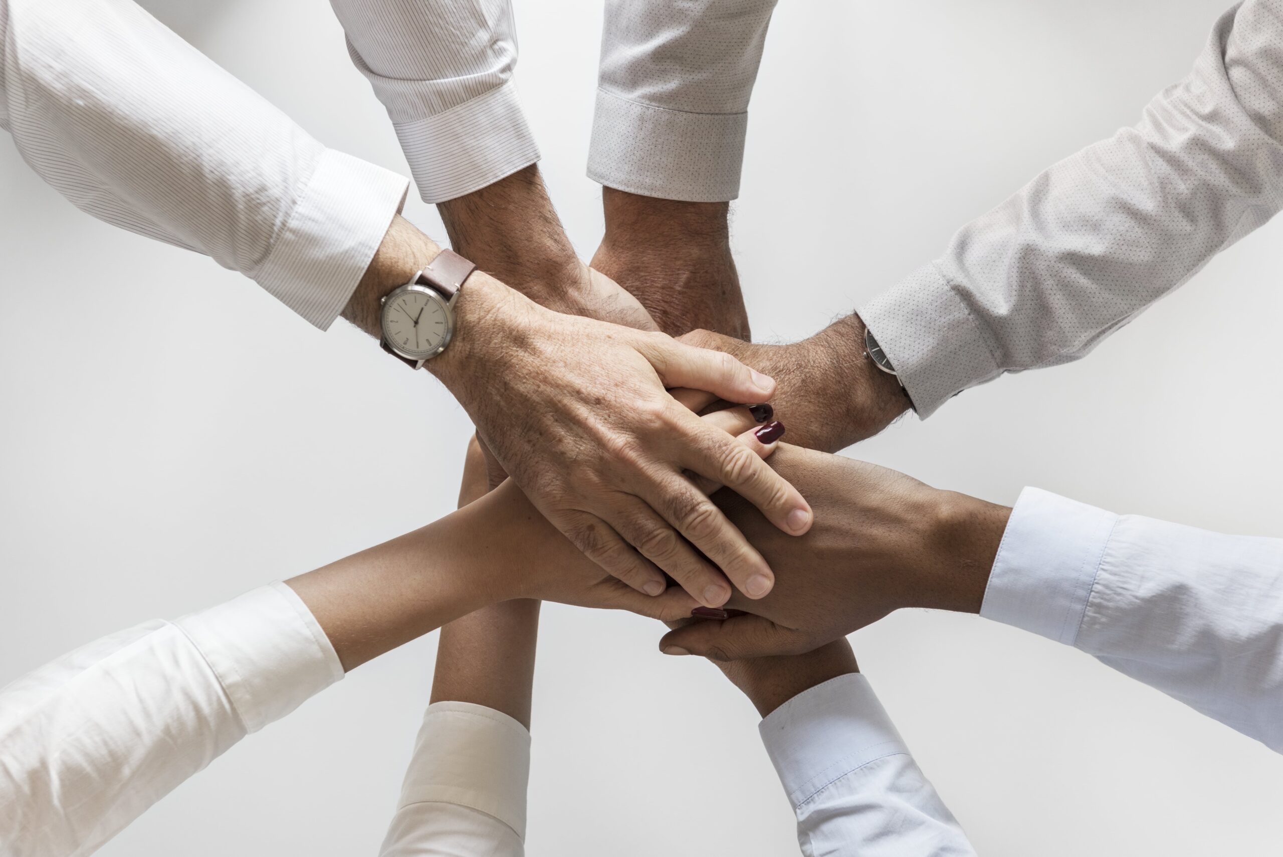 business-hands-joined-together-teamwork-min-scaled-1.jpg